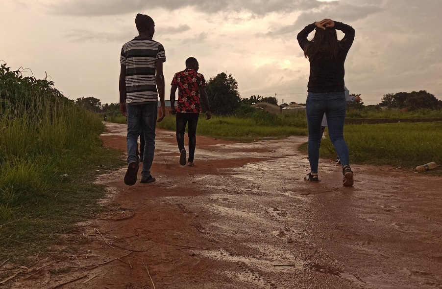 Kitti is walking with 2 Youths from the Kawama community.