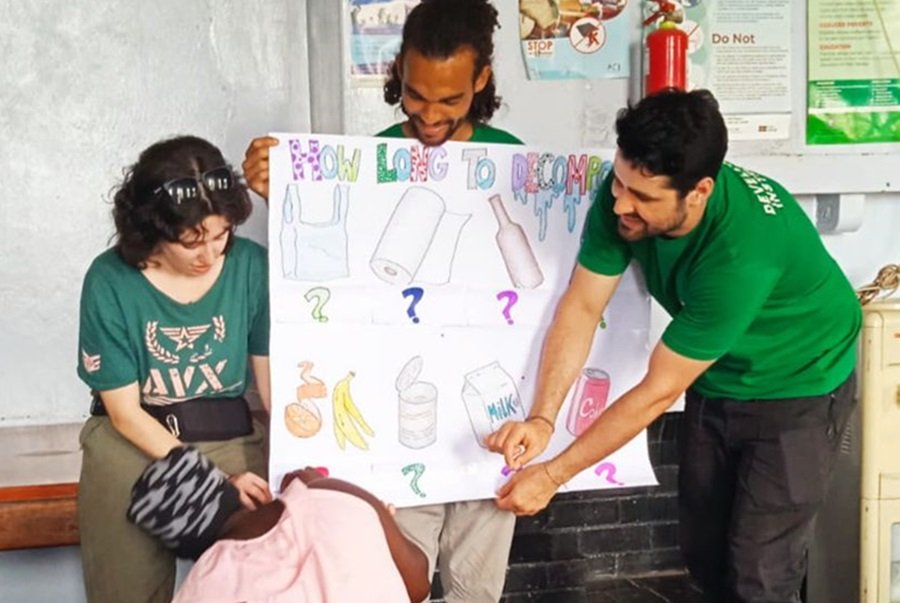 The volunteer trio in Zambia preparing to teach about garbage management