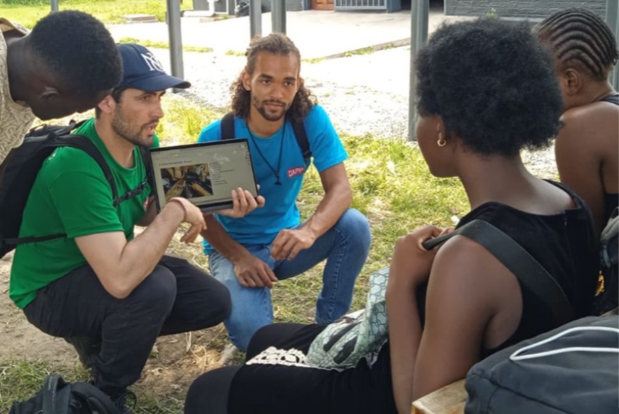 The trio with the Youth in Action group, discussing how to solve the garbage problems