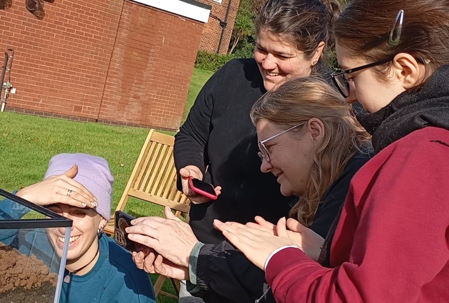 The teams are learning how to make a water filter with sand and soil